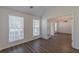 Bedroom with modern floors and lots of natural light, with view through french doors to living area at 239 Gilliam Ct, Locust Grove, GA 30248