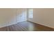 Bright bedroom with wood floors featuring window and closet with double doors at 239 Gilliam Ct, Locust Grove, GA 30248