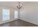 Bright dining room with wood flooring, chandelier, vaulted ceiling, and large window at 239 Gilliam Ct, Locust Grove, GA 30248