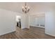 Dining room with chandelier, vaulted ceiling, and view into the kitchen and living room at 239 Gilliam Ct, Locust Grove, GA 30248