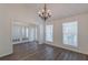 Bright dining room with chandelier, vaulted ceiling, and french doors at 239 Gilliam Ct, Locust Grove, GA 30248