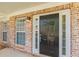 A close up of the front door and brick facade, with sidelights and decorative molding at 239 Gilliam Ct, Locust Grove, GA 30248