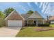 Charming single Gathering home with brick accents, manicured lawn, and a two-car garage at 239 Gilliam Ct, Locust Grove, GA 30248