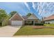 Charming single Gathering home with brick accents, manicured lawn, and a two-car garage at 239 Gilliam Ct, Locust Grove, GA 30248