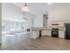 Open-concept kitchen and living area with stainless steel appliances, fireplace, and hardwood floors at 239 Gilliam Ct, Locust Grove, GA 30248