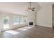 Sun-filled living room with fireplace, hardwood floors, and access to the outdoors at 239 Gilliam Ct, Locust Grove, GA 30248