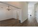 Open-concept living room with modern floors, chandelier, and view of the fireplace in the background at 239 Gilliam Ct, Locust Grove, GA 30248