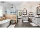 Open bathroom features a tub, glass shower, and double vanity adjacent to the bedroom at 2925 Old Broadnax Mill Rd, Loganville, GA 30052
