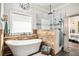 Bathroom features a modern tub and frameless glass shower with stylish wood-look accents at 2925 Old Broadnax Mill Rd, Loganville, GA 30052