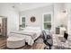 Bright bedroom with light gray walls and wood flooring; includes a work space and stylish decor at 2925 Old Broadnax Mill Rd, Loganville, GA 30052