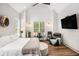 Comfortable bedroom features wood floors, sitting area, work space, and a mounted flat screen TV at 2925 Old Broadnax Mill Rd, Loganville, GA 30052