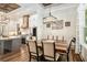 Open dining room with wood floors, a wooden table, and white kitchen in the background at 2925 Old Broadnax Mill Rd, Loganville, GA 30052