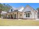 Inviting home with a spacious front porch, showcasing the architectural details and beautifully landscaped yard at 2925 Old Broadnax Mill Rd, Loganville, GA 30052