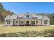 Charming home boasts a welcoming front porch, perfect for relaxing and enjoying the beautifully maintained lawn at 2925 Old Broadnax Mill Rd, Loganville, GA 30052