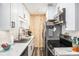 Kitchen with white cabinets, stainless steel appliances, and modern finishes at 2925 Old Broadnax Mill Rd, Loganville, GA 30052