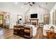 Stylish living room featuring hardwood floors, shiplap accent wall, wood beam ceiling, and ample natural light at 2925 Old Broadnax Mill Rd, Loganville, GA 30052