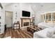 Bright living room with a cozy fireplace, elegant wood floors, and a vaulted ceiling design at 2925 Old Broadnax Mill Rd, Loganville, GA 30052