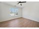 Bright bedroom with ceiling fan, wood-look floors, and large windows at 439 Wind Walk Cir, Lawrenceville, GA 30044