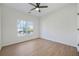 Well-lit bedroom featuring wood flooring and a window with backyard views at 439 Wind Walk Cir, Lawrenceville, GA 30044