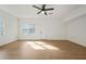 Bright, open bedroom with wood flooring, a ceiling fan and natural light at 439 Wind Walk Cir, Lawrenceville, GA 30044