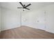 Open bedroom featuring a ceiling fan, wood-look floors and closets at 439 Wind Walk Cir, Lawrenceville, GA 30044