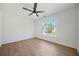 Sunlit bedroom featuring a ceiling fan, wood-look floors, and large windows at 439 Wind Walk Cir, Lawrenceville, GA 30044