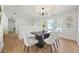 Elegant dining room with modern light fixture, wainscotting and hardwood flooring at 439 Wind Walk Cir, Lawrenceville, GA 30044