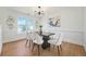 Contemporary dining room boasts modern light fixture, wainscotting and stylish decor at 439 Wind Walk Cir, Lawrenceville, GA 30044
