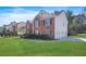 Beautiful house featuring an attached three-car garage and green lawn with manicured shrubbery at 439 Wind Walk Cir, Lawrenceville, GA 30044