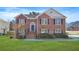 Charming two-story brick home featuring a well-manicured lawn and inviting front entrance at 439 Wind Walk Cir, Lawrenceville, GA 30044