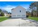 Spacious three-car garage with a large concrete driveway and a well-manicured lawn at 439 Wind Walk Cir, Lawrenceville, GA 30044