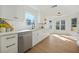 Bright kitchen featuring stainless steel appliances, white cabinetry, and hardwood floors at 439 Wind Walk Cir, Lawrenceville, GA 30044