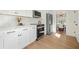 Bright, modern kitchen with stainless steel appliances, white cabinets, and hardwood floors at 439 Wind Walk Cir, Lawrenceville, GA 30044