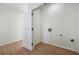 Unfinished laundry room with hookups and wood-look flooring at 439 Wind Walk Cir, Lawrenceville, GA 30044