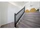 Staircase with gray wood-look steps and modern black railing leads to the main floor at 439 Wind Walk Cir, Lawrenceville, GA 30044