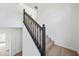 Staircase with wood-look steps and modern black railing at 439 Wind Walk Cir, Lawrenceville, GA 30044