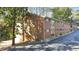 Multi-story brick apartment complex featuring parking and mature trees at 1135 Clairemont Ave # B, Decatur, GA 30030