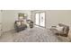 Bright living room featuring a modern chair, gray sofa and a sliding door at 1135 Clairemont Ave # B, Decatur, GA 30030