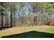The backyard offers a tranquil setting with lush greenery and mature trees at 4150 Soaring Dr, Douglasville, GA 30135