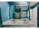 Bathroom with double vanity, large mirror, and bright blue walls at 4150 Soaring Dr, Douglasville, GA 30135