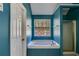 Bright bathroom features a large soaking tub under a window and a glass enclosed shower at 4150 Soaring Dr, Douglasville, GA 30135