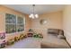 Cozy bedroom decorated as playroom with natural light, comfortable seating, and playful decor at 4150 Soaring Dr, Douglasville, GA 30135