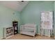 Charming Bedroom with calming colors, a white crib, and ample storage space for a soothing atmosphere at 4150 Soaring Dr, Douglasville, GA 30135