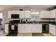 Well-equipped kitchen with modern appliances, white cabinets and ample counter space at 4150 Soaring Dr, Douglasville, GA 30135