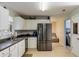 Functional kitchen with stainless steel refrigerator and access to the living room at 4150 Soaring Dr, Douglasville, GA 30135