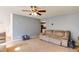 Spacious living room featuring plush carpeting, ceiling fan and access to other rooms at 4150 Soaring Dr, Douglasville, GA 30135