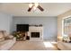 Cozy living room with a decorative fireplace, neutral tones, and ample natural light at 4150 Soaring Dr, Douglasville, GA 30135