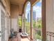 Private balcony with seating and a view of the city skyline beyond mature trees at 50 Biscayne Nw Dr # 6117, Atlanta, GA 30309