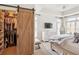 Bright bedroom with a large closet, a wooden sliding door, and tray ceiling at 50 Biscayne Nw Dr # 6117, Atlanta, GA 30309