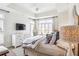 Bright bedroom with a white dresser, big windows, and a tray ceiling at 50 Biscayne Nw Dr # 6117, Atlanta, GA 30309